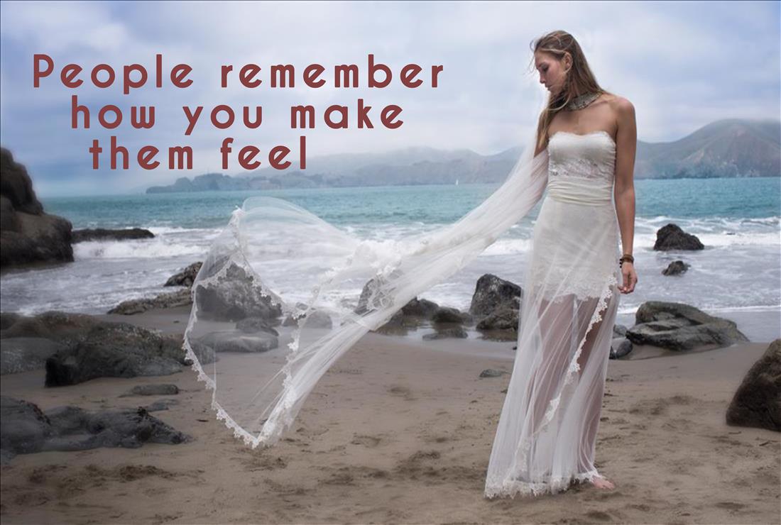 Woman in windblown wedding dress on beach