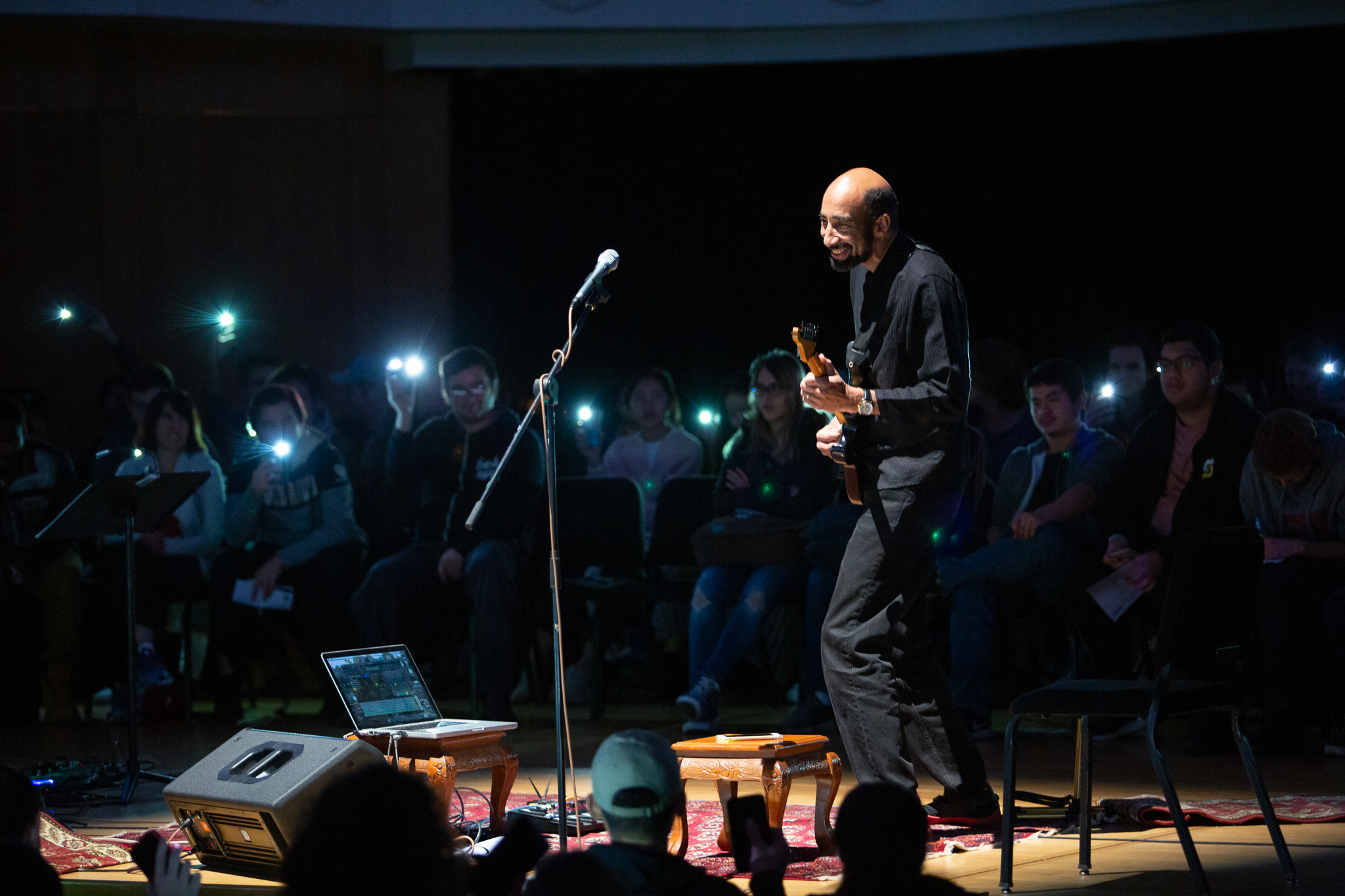Gregory Walker playing guitar on stage
